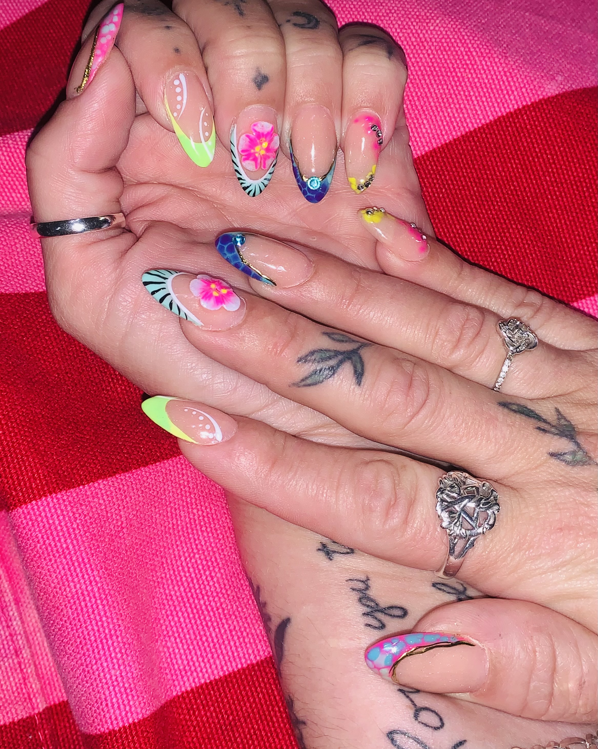 Detailed acrylic nail art with rhinestones